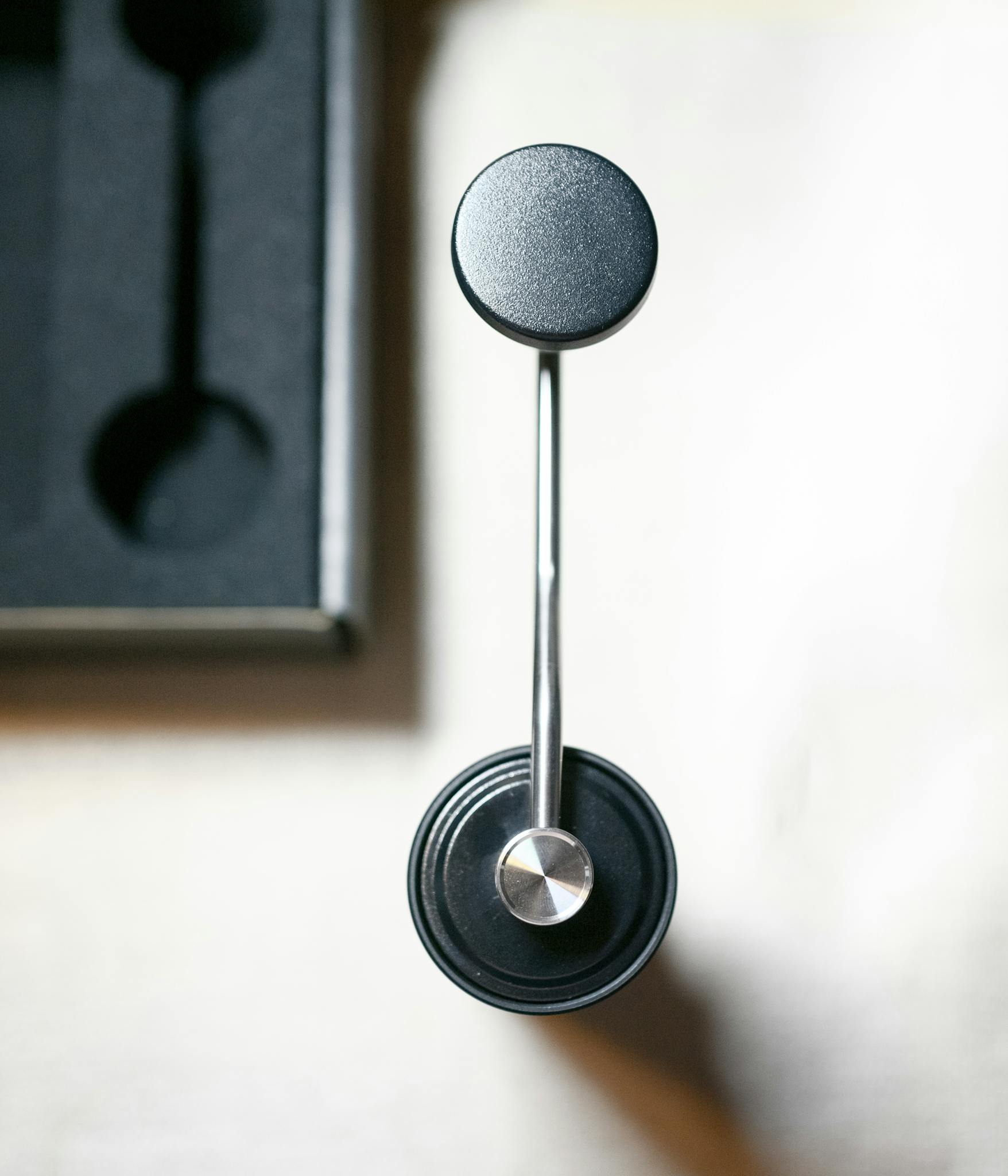 Sleek coffee bean grinder viewed from above, shot indoors in Tokyo, Japan.